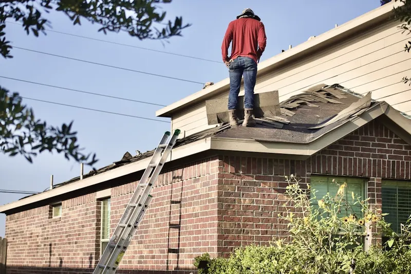 Professional roofer working on a residential roof in Claymont Terrace